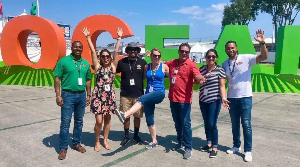 Group of people in front of the OC Fair Sign at the entrance.