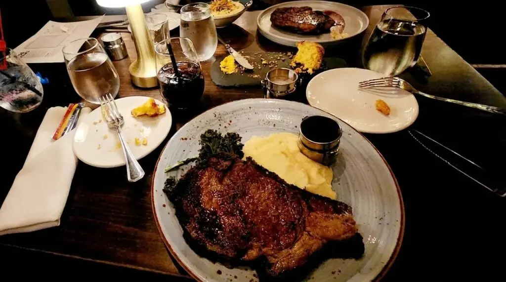 Orange Hill Steakhouse in Orange. Steak platter on a dining room table.