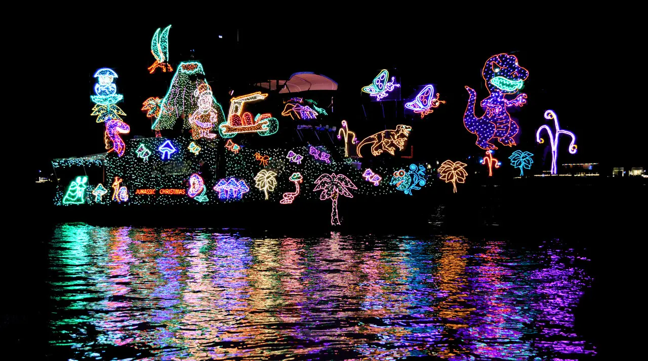 Decorated yacht covered in Christmas lights during the Newport Beach Christmas Boat Parade in Newport Harbor