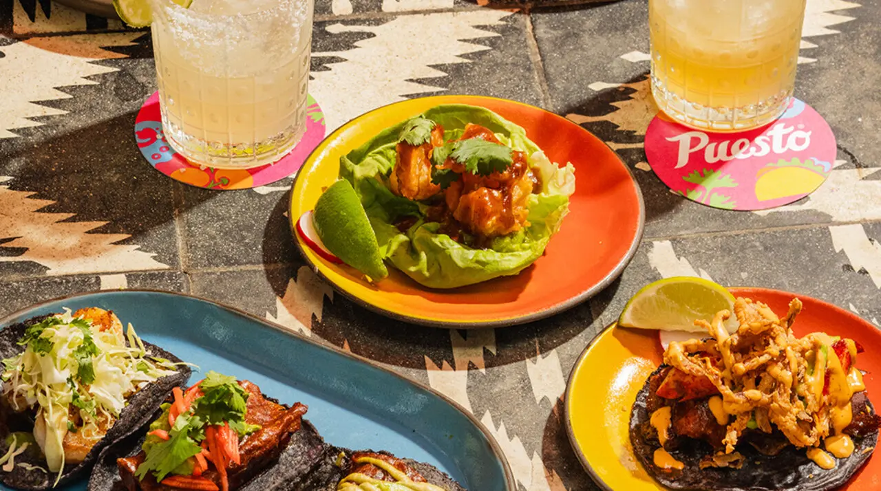 Handmade blue corn tacos and crispy melted-queso taco at Puesto Park Place in Irvine, attached to the AC Hotel