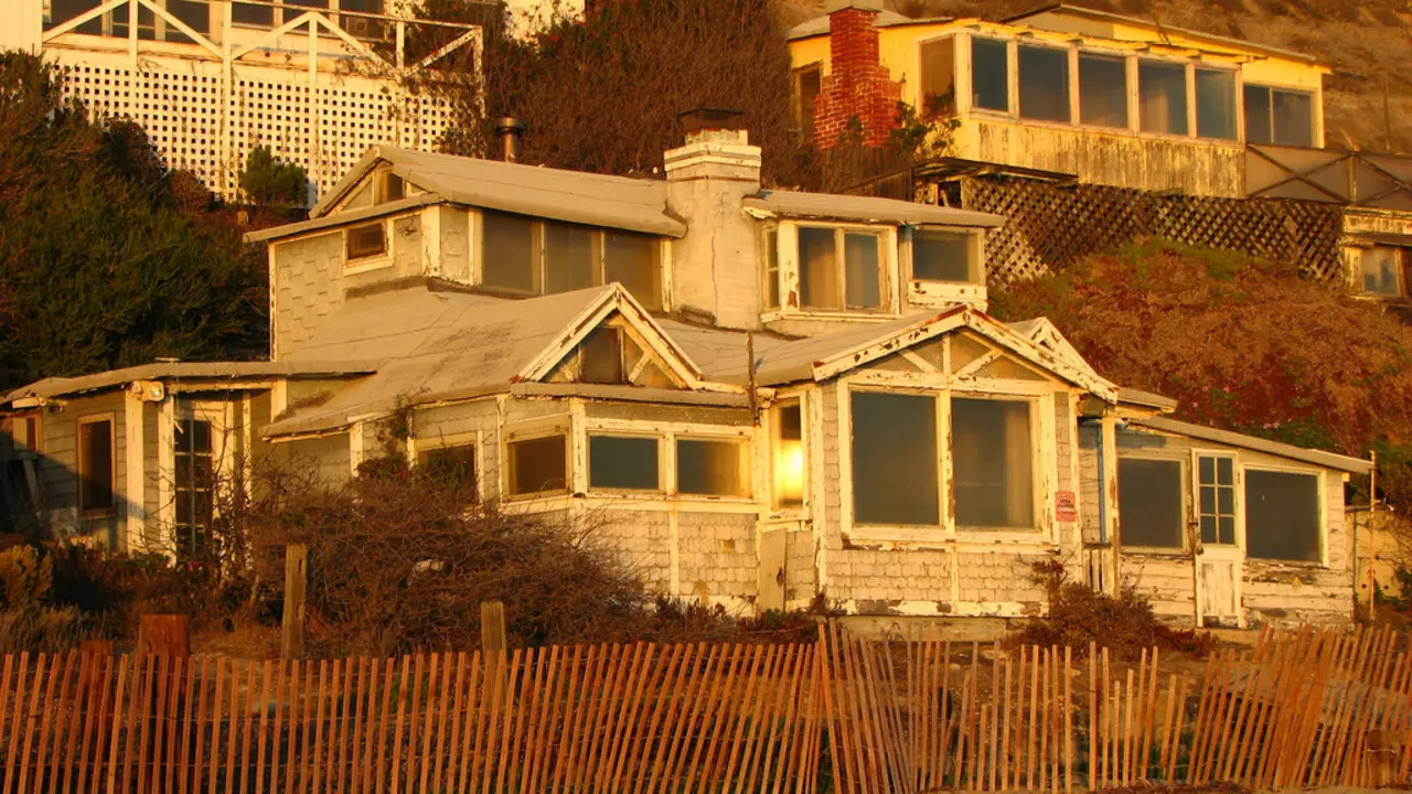 Historic beach cottages along the sand at Crystal Cove Historic District for a free sunset date night
