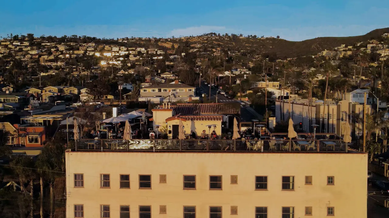 Sunset crowd on The Rooftop Lounge deck at La Casa del Camino in Laguna Beach for an Orange County date night