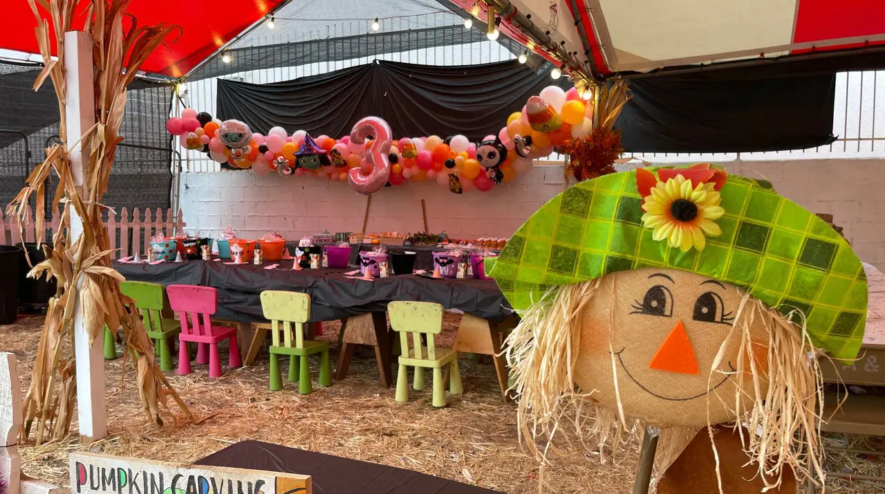 Pumpkin carving and decorating tent with scarecrow at a Mr. Jack O' Lanterns pumpkin patch